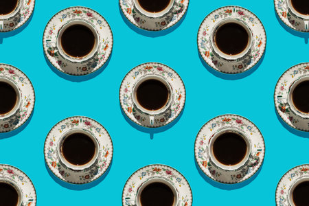 Coffee in vintage and antique floral china cups pattern on blue background.