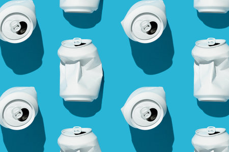 Crushed white beverage cans pattern on the bright blue background. Minimal concept.の写真素材