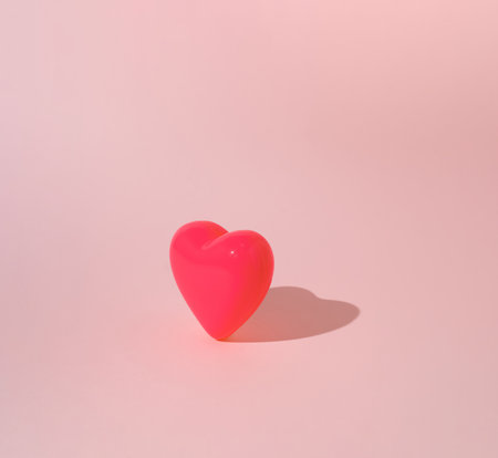 Pink heart on pastel background. Minimal Valentine's or love concept.の写真素材