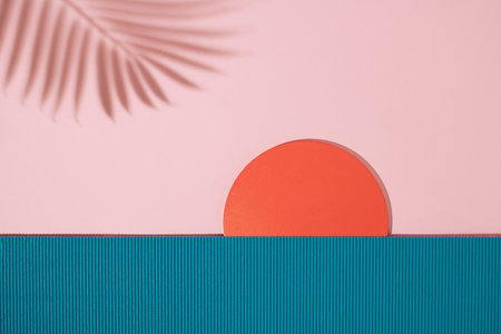 Sunset beach landscape scene made with ribbed paper, wooden circle and palm leaf shadow.の写真素材