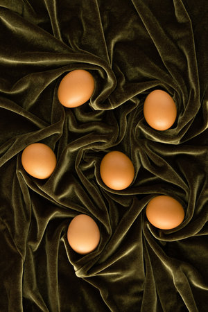 Fresh chicken eggs on luxurious green plush. Minimal concept. Flat lay.の写真素材
