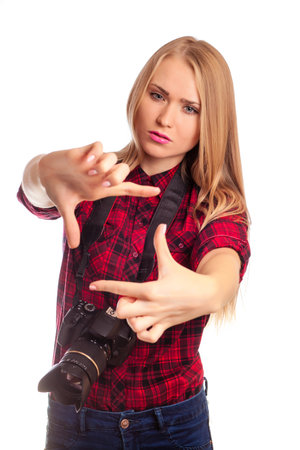 Attractive Female amateur photographer holding a professional camera - isolated over whiteの写真素材