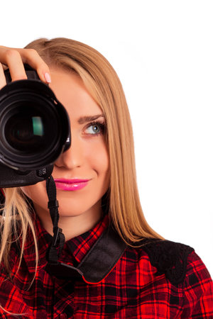 Half of a face of female photographer holding a professional camera - isolated over whiteの写真素材