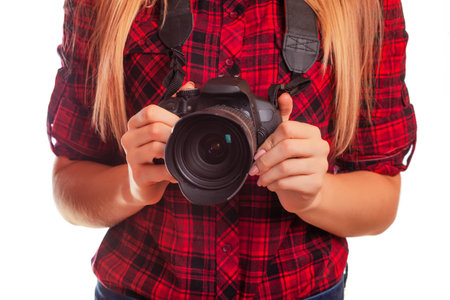 Bode part of female photographer holding a professional camera - isolated over whiteの写真素材