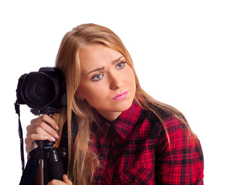 Female photographer relying on tripod tired isolated over whiteの写真素材
