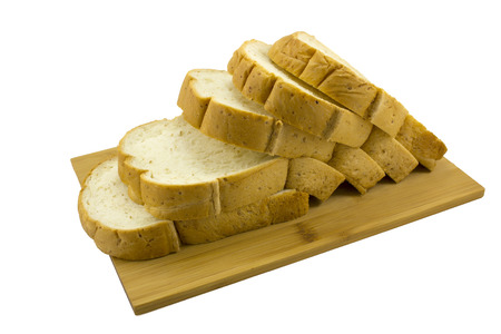 Isolated loaf of whole wheat sandwich bread on wooden board
