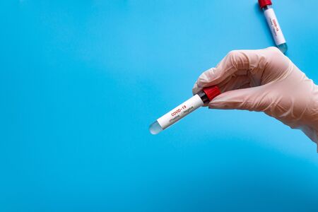 Thin blue medical gloves and protective face masks on a blue background. Disposable gloves and masks...