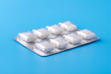 Chewing gum on a beautiful blue background with space for your inscription.