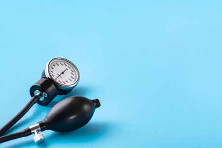 Device for measuring blood pressure. Tonometer, cuff, stethoscope on a blue background. Copy-space.の写真素材