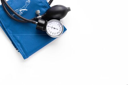 Device for measuring blood pressure. Tonometer, cuff, stethoscope on a white background. Top view. The place to insert the text. Copy-spaceの写真素材