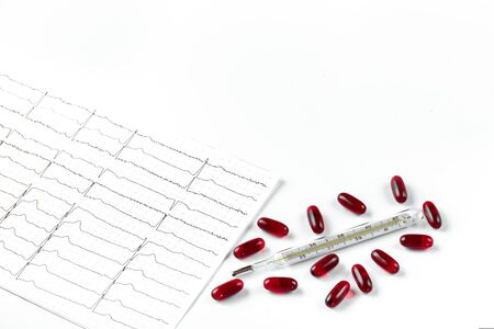 Mercury thermometer, tablets and cardiogram on a white background. Concept of body temperature control, health and treatment. Space for text. Copy space.の写真素材