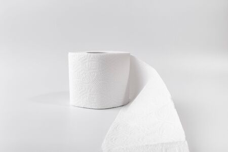 A roll of toilet paper on a white background. Copy space. Space for text.