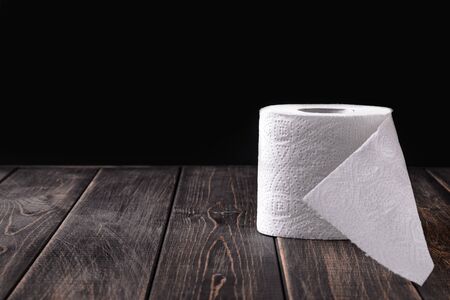 A roll of toilet paper on a wooden background. Copy space. Space for text.の写真素材