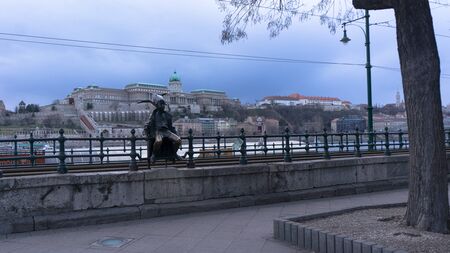 Budapest, Hungary 03 15 2019 the Little Princess (KiskirÃ¡lylÃ¡ny) statue sitting on the railings of the Danube promenade in Budapest, Hungary was created by LÃ¡szlÃ³ Martonのeditorial素材