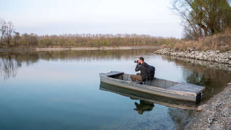 Asvanyraro Hungary 03 27 2020: He takes a nature photo of a boat on the Danube.