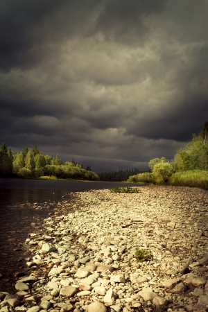 Photo storm clouds over the riverの写真素材