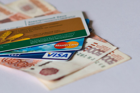 credit and debit cards of international systems Visa and MasterCard over paper banknotes of 5000 rubles. Volgograd region, October 1, 2016のeditorial素材