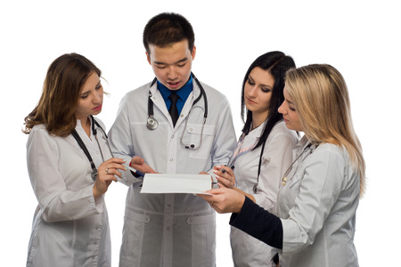 young doctors are reading documents attached to black clipboardの写真素材