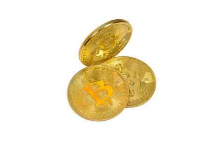 Three yellow metal coins (bitcoin) isolated against white backgroundの写真素材