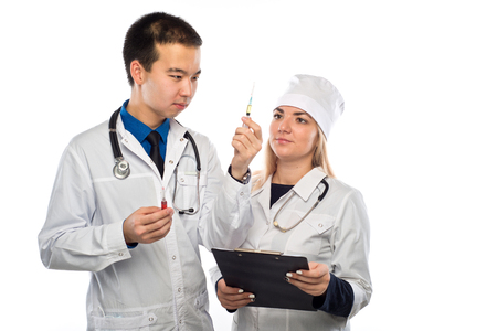 a young doctor of Asian appearance, shows a syringe with red liquid, a young girl doctorの写真素材