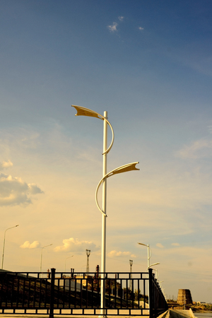 Modern led street lamp to illuminate the space under your feet, against the blue skyの写真素材
