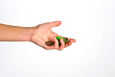 House key with trinket house in the female palm. Rental estate. Sale property template.の写真素材
