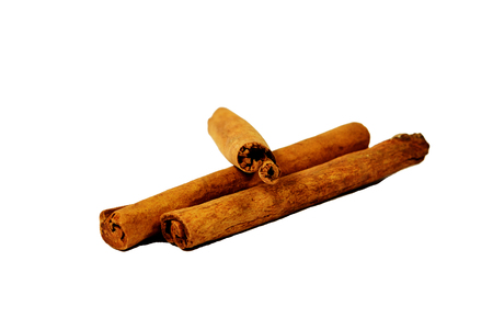 Tossed cinnamon sticks isolated on white backgroundの写真素材