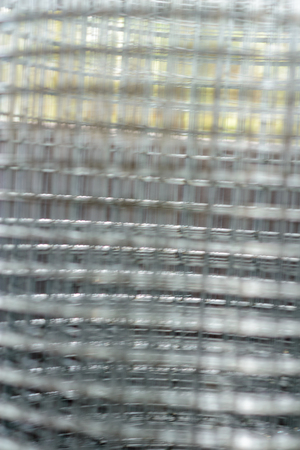 Industrial rolls of aluminum chain link fencing.close up steel wire net texture for background.Rolls of steel wire mesh for use of fencing.Close up of wire mesh fence in rollの写真素材