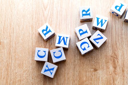 Children's wooden cubes with the Latin alphabet on the wooden floorの写真素材