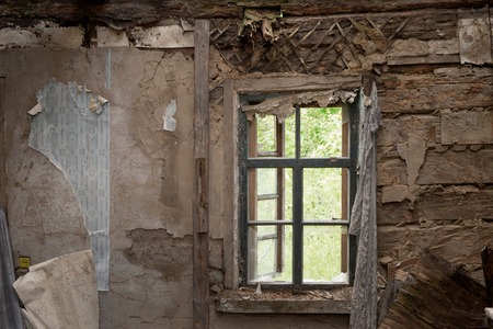 An old abandoned brick house with a broken window, closeup. As background for design of crisisの写真素材
