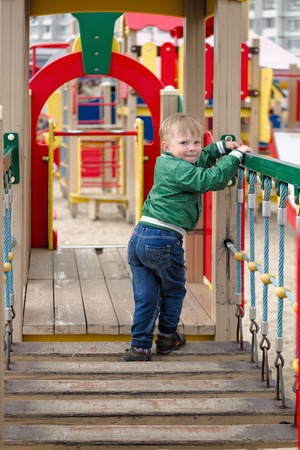 children play on the playground. early spring.の写真素材