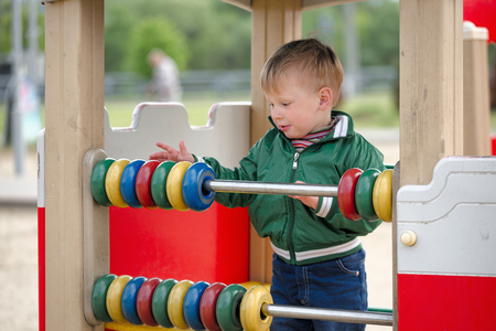 children play on the playground. early spring.の写真素材
