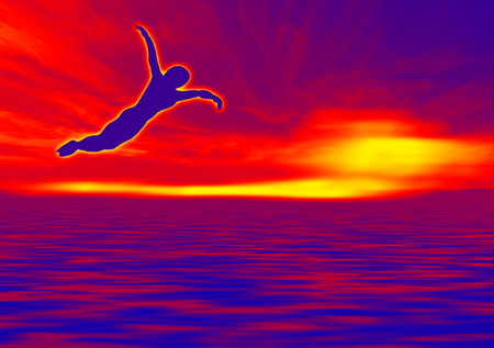 silhouette of a man to dive, against a blue cloudy skyの写真素材