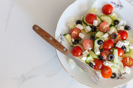 Greek salad on light backgroundの写真素材