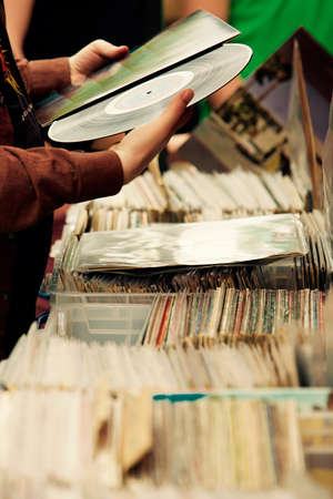 Close up on hands choosing LP recordsの写真素材