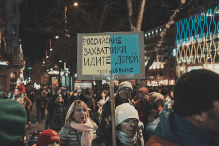 Striking school aged children in central London over climate change holding a placardの写真素材
