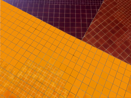 Shiny deep yellow, brown and violet tile wallの写真素材