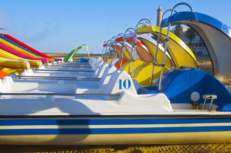 View on the line of multicolored pleasure boats, beach, summer