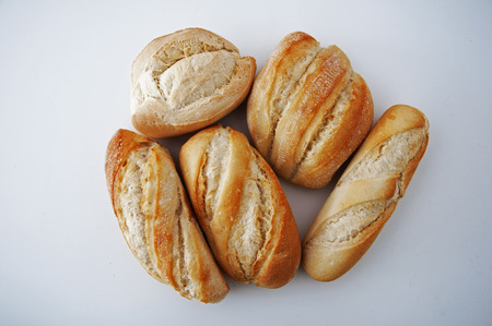 Five small different type of breads on the white background, close up