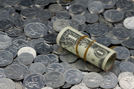 Roll of One Dollar Bills on coins backgroundの写真素材