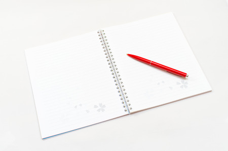 Opened new notebook and red pencil placed on the gray backgroundの写真素材