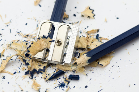 Blue broken pencil in the sharpening and shavings around