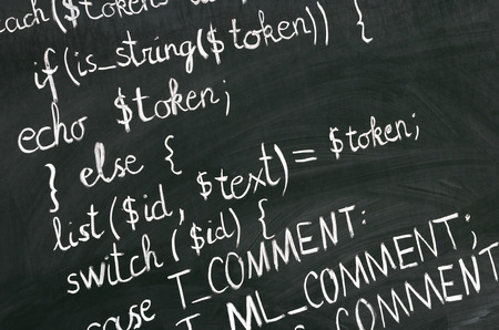 A detail of computer code in PHP explained with white chalk