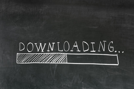 Downloading handwritten with white chalk on a blackboard and drawing download barの写真素材