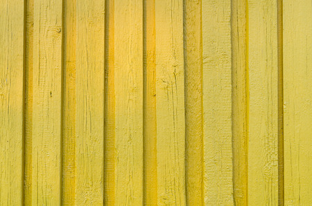 Old bright yellow wooden plank wall backgroundの写真素材