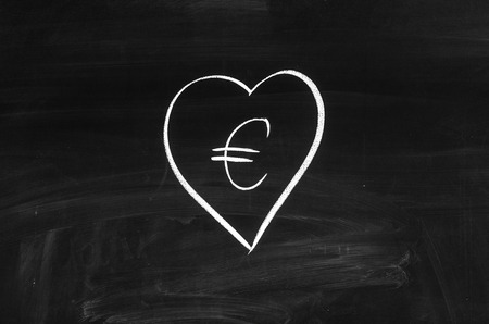 Euro sign drawn in the heart shape figureの写真素材