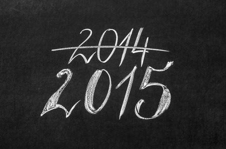 New Year coming concept - 2015 and 2014 written on a blackboard