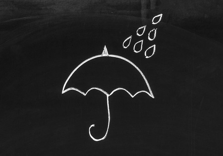 Chalk Drawing Of An Umbrella And Rain Drops On The Blackboardの写真素材