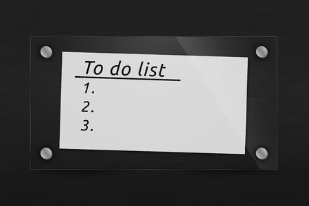 Behind glass sheet of paper with a list of worksの写真素材