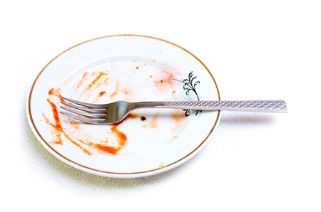 An empty plate dirty after the meal is finished.の写真素材